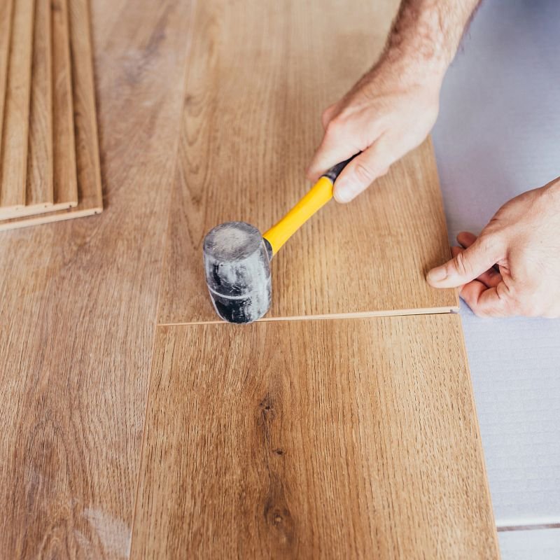 Person installing engineered hardwood flooring from Southwest Floors in Seven Hills, OH