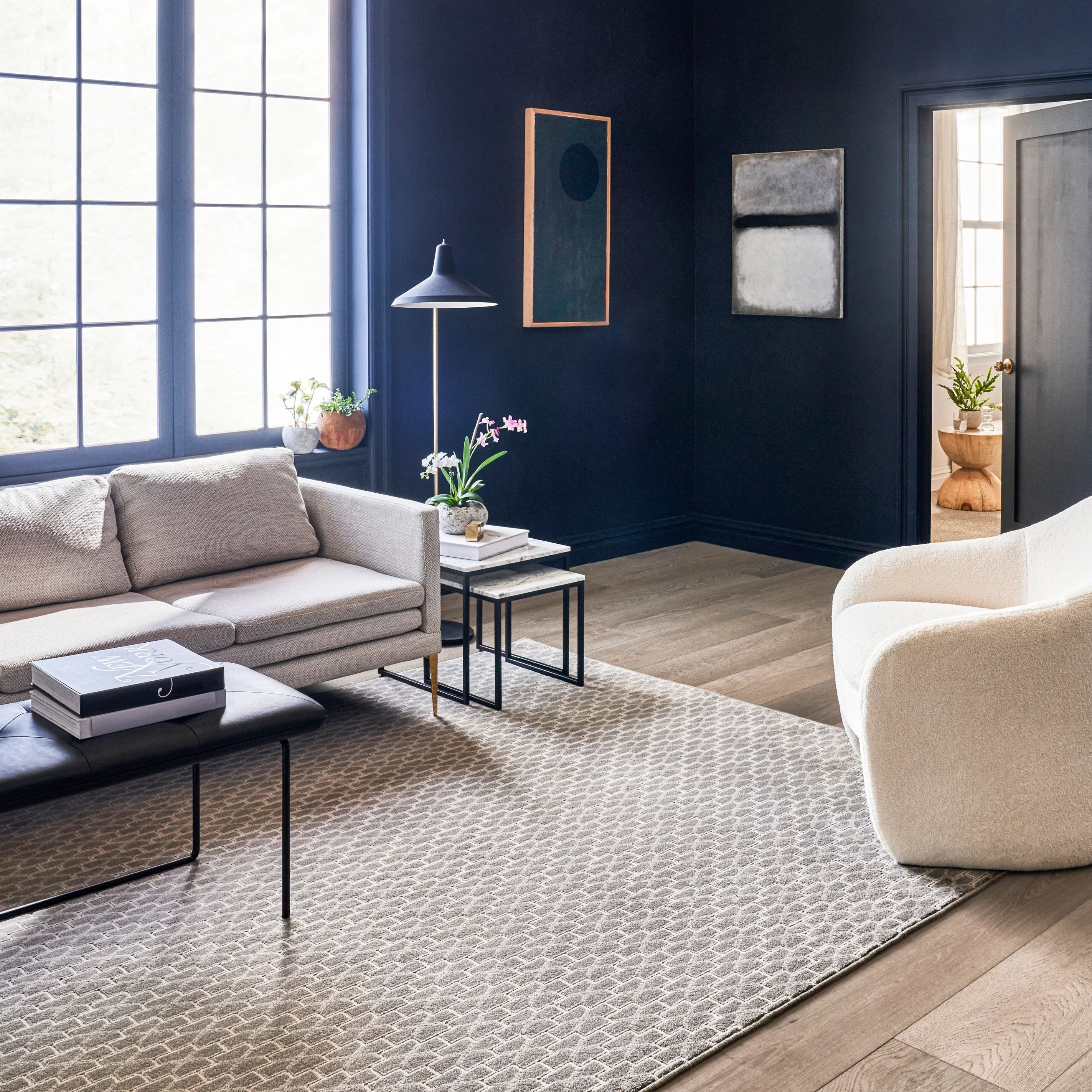 Living room with blue walls, hardwood flooring and a large beige patterned area rug from Southwest Floors in Seven Hills, OH