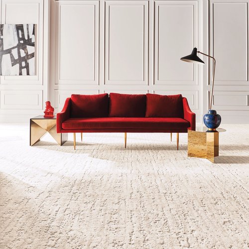 Bright living room with red velvet couch and a beige textured carpet from Southwest Floors in Seven Hills, OH